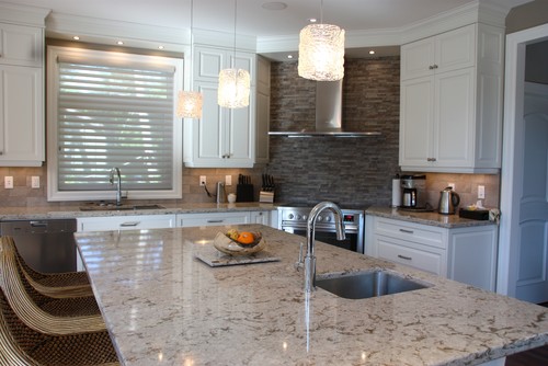 Cambria Windermere with White Cabinets, Travertine and Natural Slate Backsplash, Stainless Steel Appliance and Stainless Steel Vent Hood and Textured Kitchen Pendant Lights